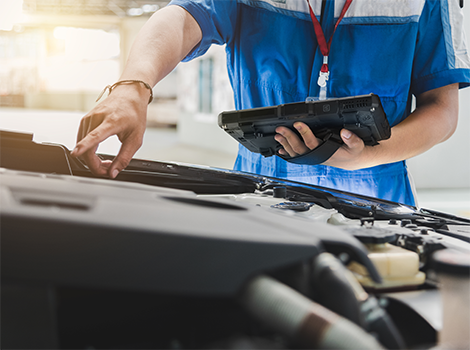 Automotive technician using a getac rugged tablet to carry out an Electronic Vehicle Health Check