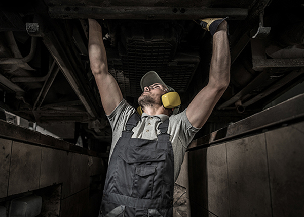 Male mechanic working on a commercial bus