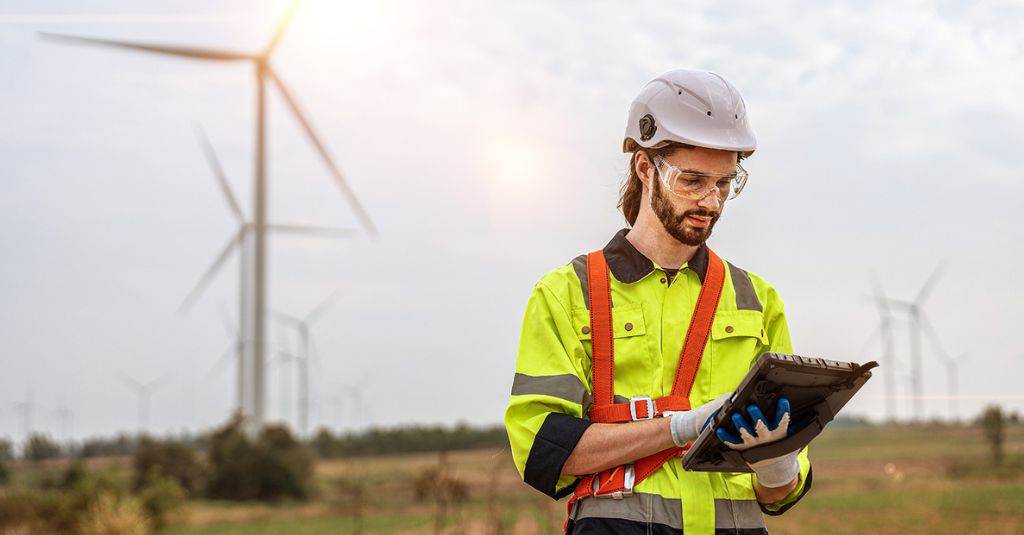 utility field worker looking at a rugged tablet