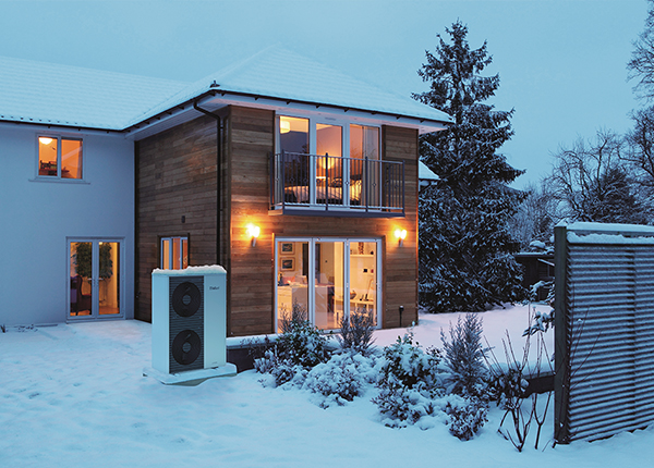Illuminated family home in snow
