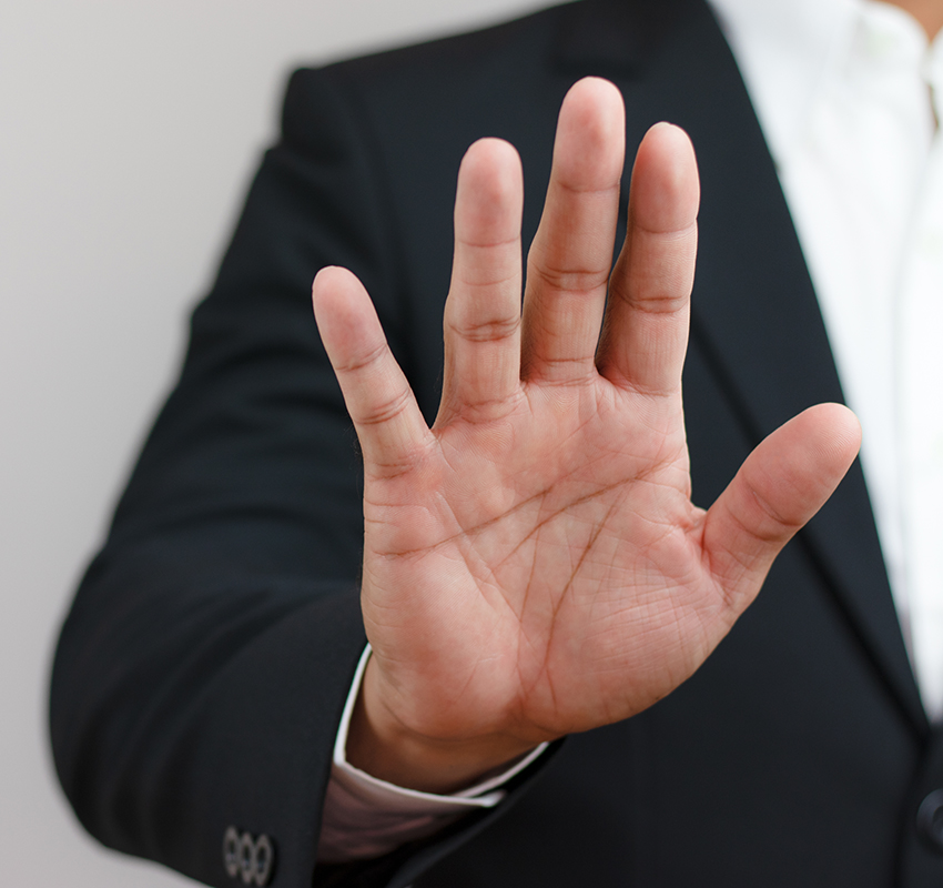 Businessman,Raising,His,Hand,In,Front,Indicating,Order,To,Stop,