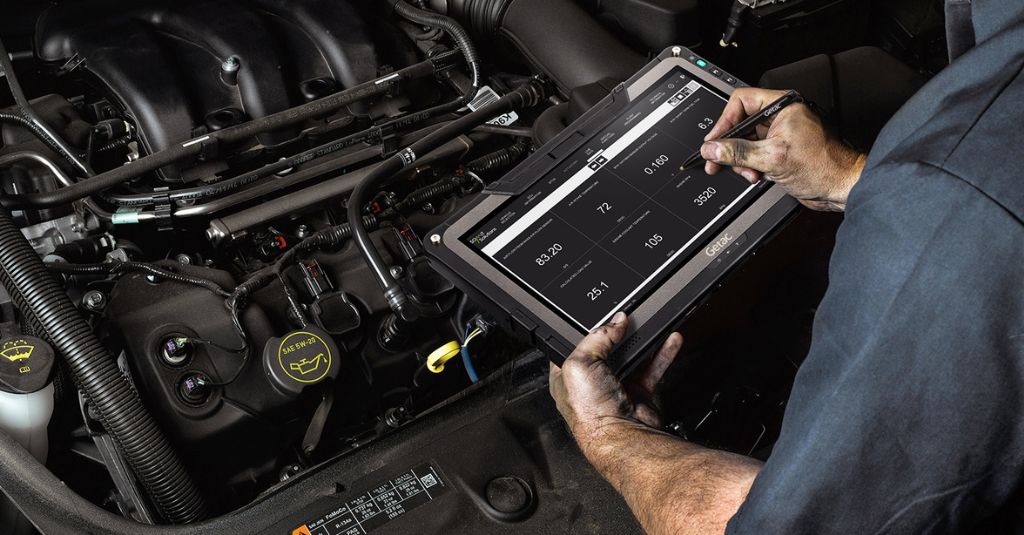 Technician using Getac rugged tablet to document automotive repairs