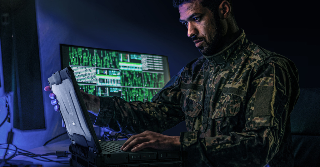 Military operator using a Getac rugged laptop in a secure command environment, demonstrating customized, mission-ready computing for defense operations and cyber-secure data handling.