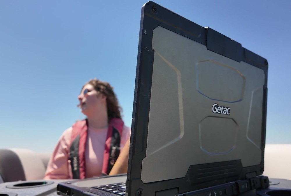 Getac B360 rugged laptop with the Getac logo on its lid, used on a boat by Delaware Center for the Inland Bays staff