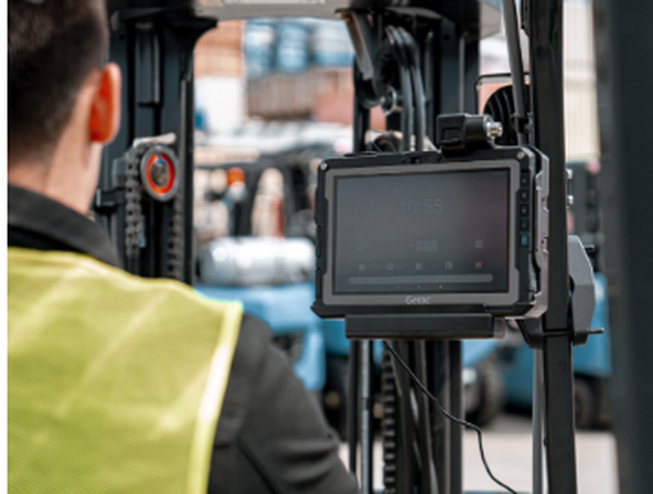 Telecom technicians using a Getac B360-fully-rugged laptop to inspect network infrastructure equipment in a field deployment environment