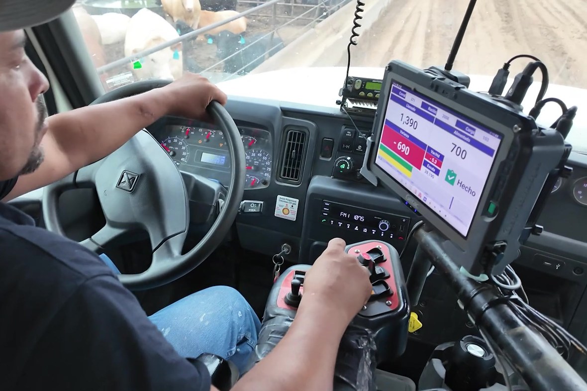 Feed truck driver delivering a ration with a Getac ZX10 rugged tablet mounted beside the steering wheel